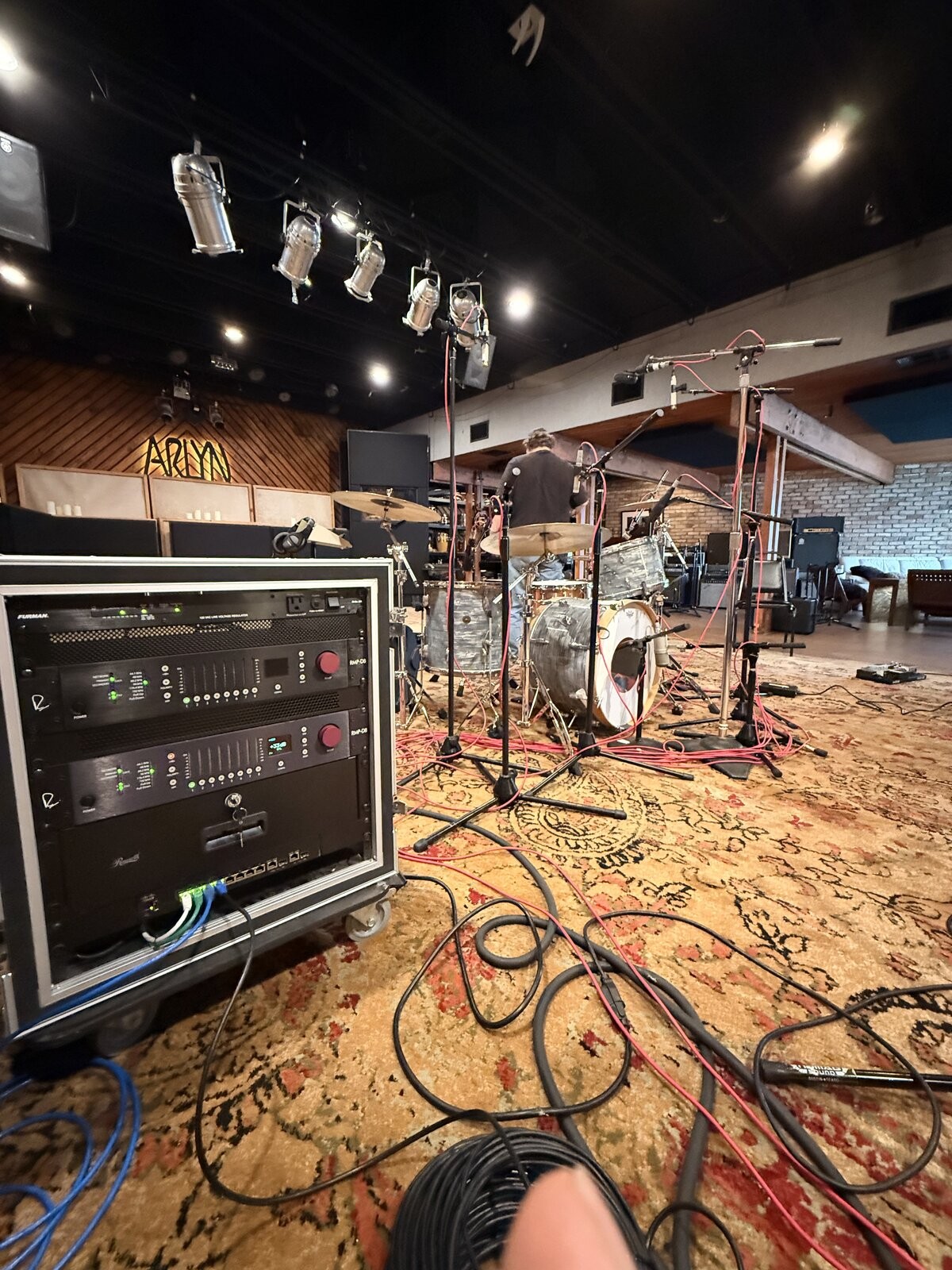 Drums set up, with the Dante preamp rack out on the floor